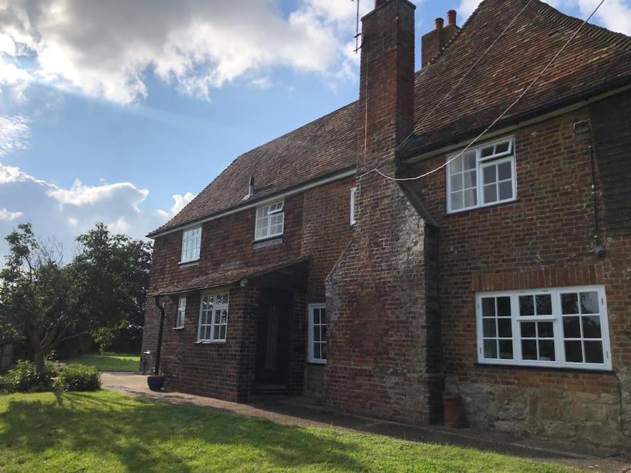 an old brick house with its door open at Spacious character cottage overlooking fields in Harrietsham