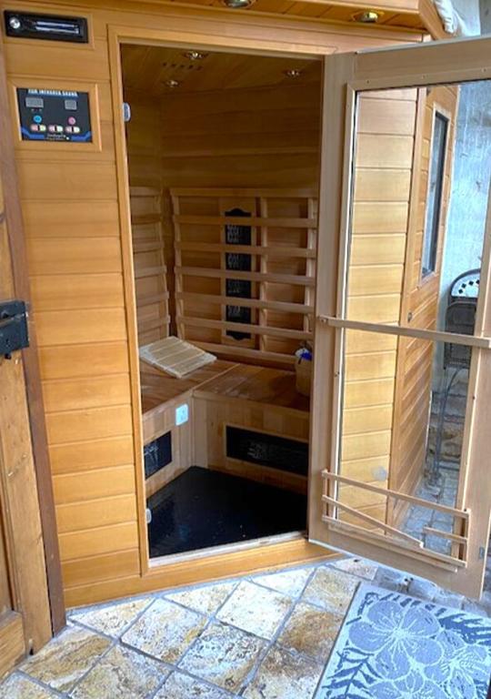 a large glass door of a sauna in a house at Gemütliche Hof Wohnung in St Martin mit Sauna in Sankt Martin