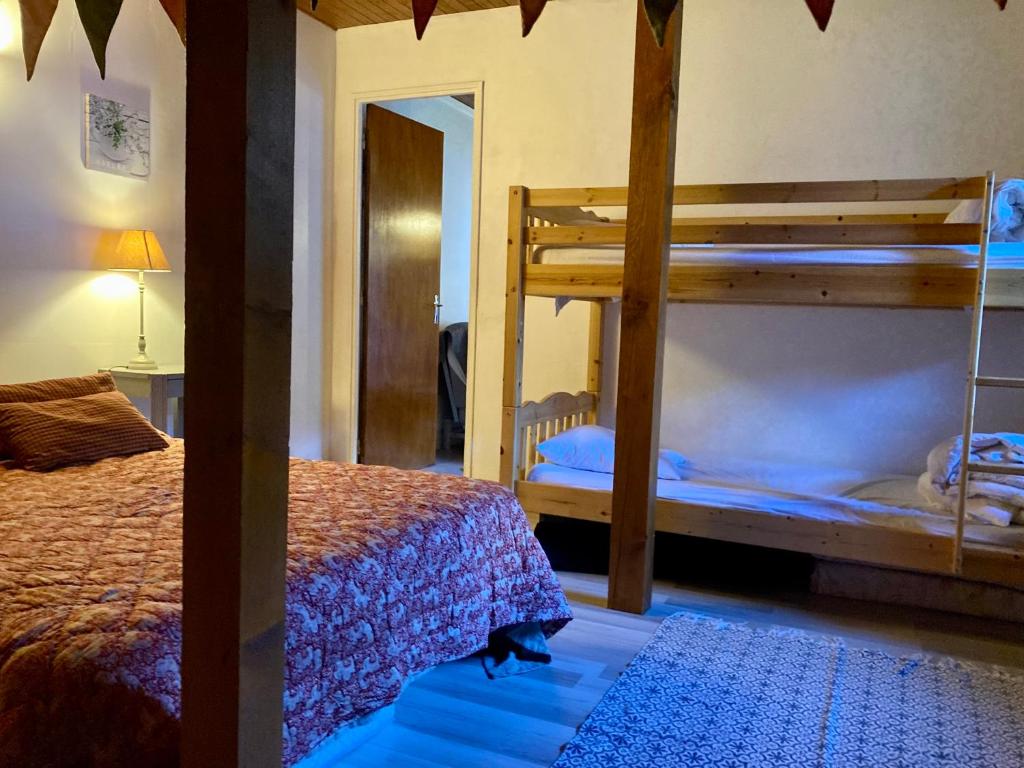 a bedroom with two bunk beds and a mirror at Chez papa et maman in Eaux-Bonnes