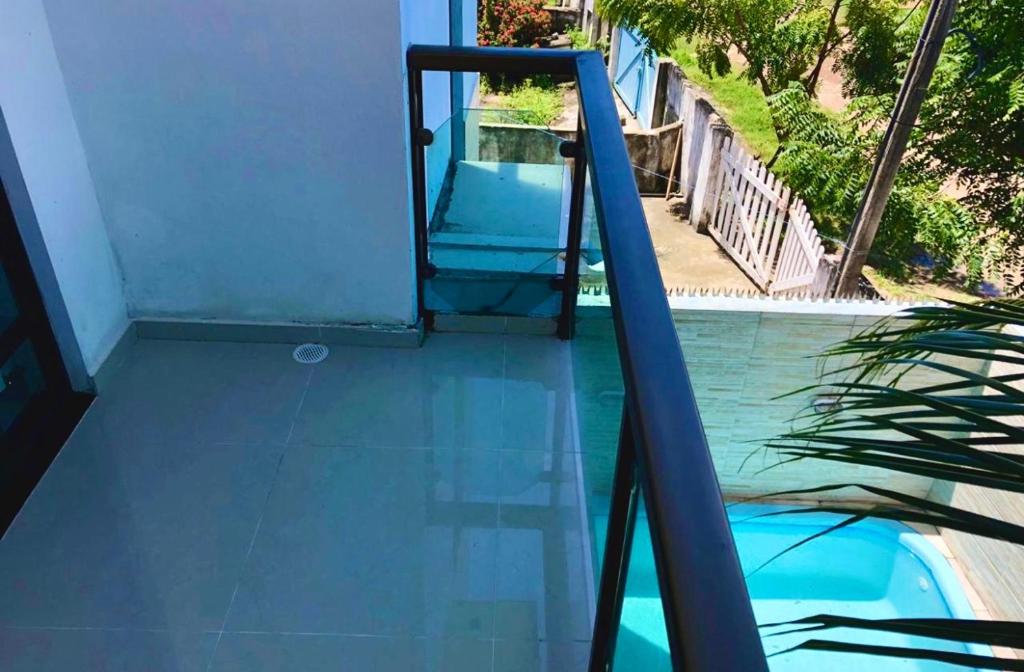 a glass door leading into a swimming pool at CASA EM PORTO DE GALINHAS in Porto De Galinhas
