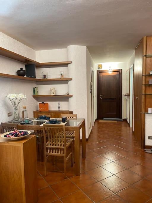 a kitchen with a table and chairs in a room at LUW casa a Madonna di Campiglio in Madonna di Campiglio