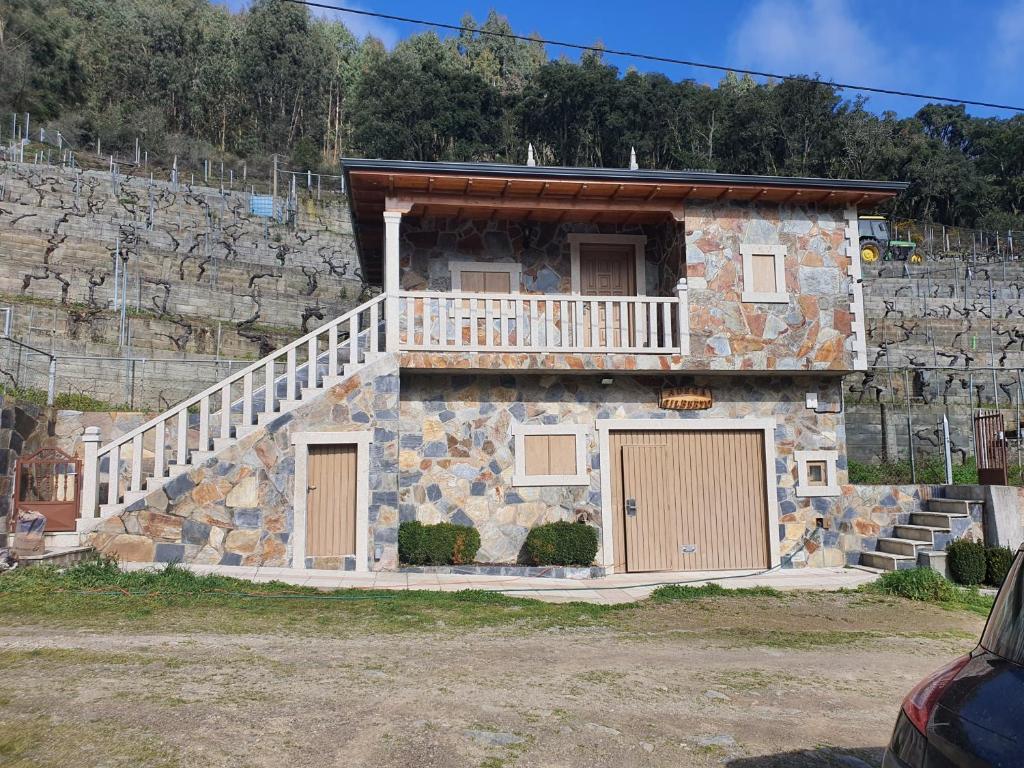 a stone house with a staircase on the side of it at SAMPAIO in Taboada