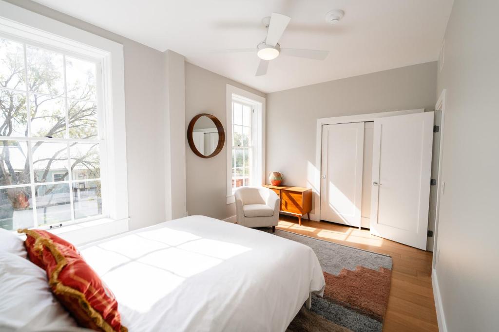 a bedroom with a white bed and a window at Western 1924 Luxury Lofts in Martindale