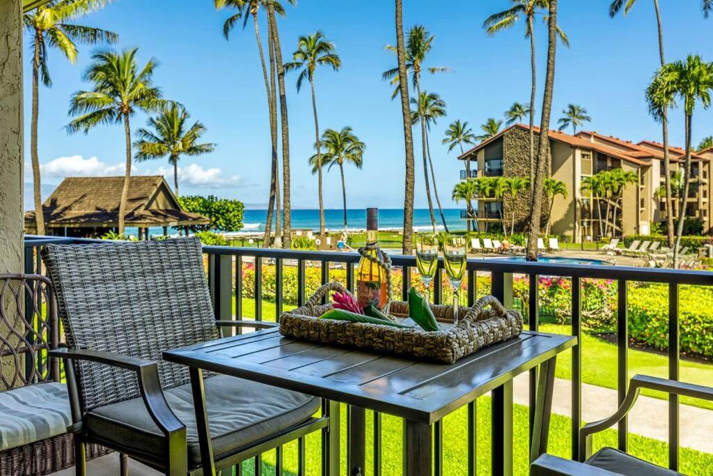 a table on a balcony with a view of the beach at Papakea E206- Updated Papakea oceanview condo, all the amenities in Kahana