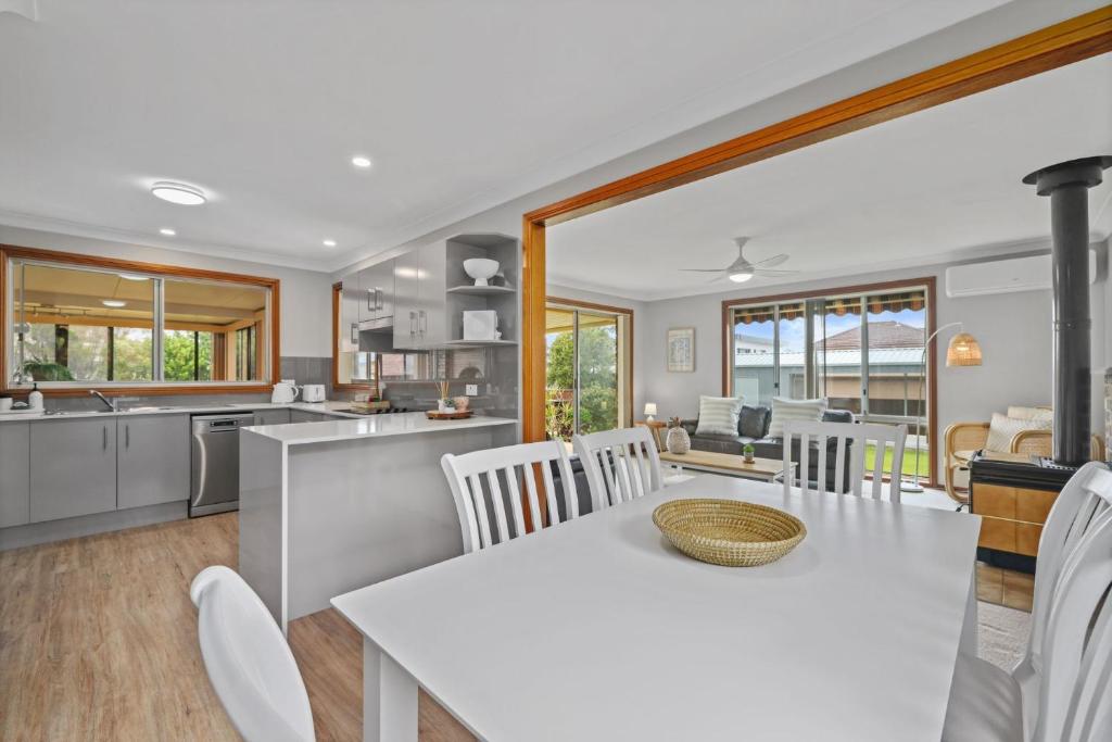 a kitchen and living room with a table and chairs at Ocean Breeze Vincentia by Book Jervis Bay in Vincentia