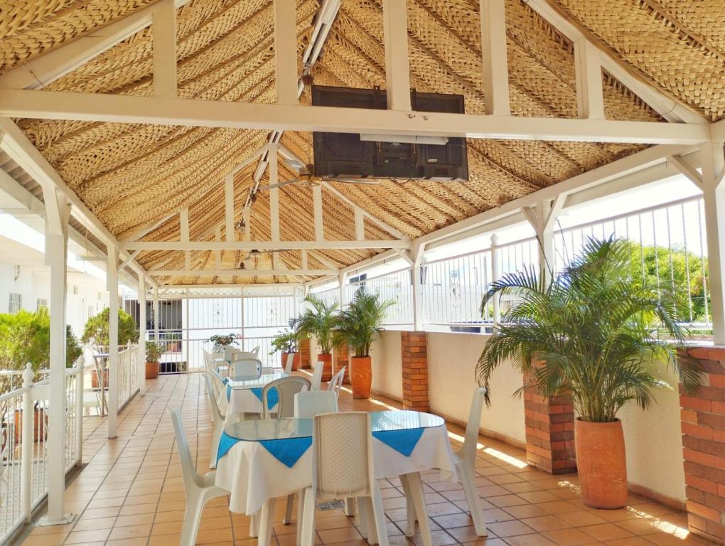 a room with a table and chairs in a building at Hotel Orquídea Real in Valledupar