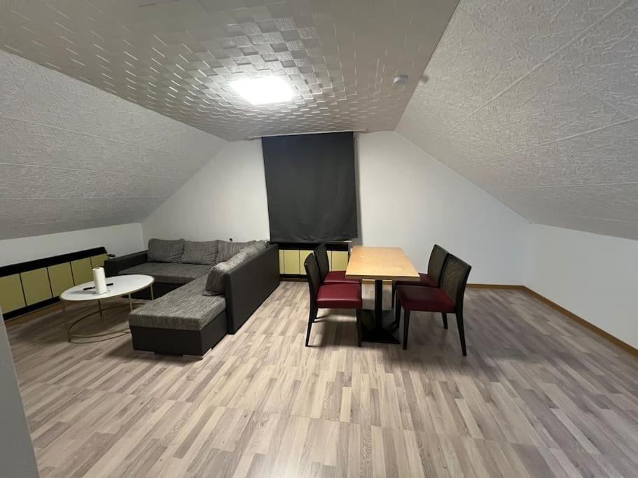 uma sala de estar com um sofá, uma mesa e cadeiras em Wohnung in Herford em Herford