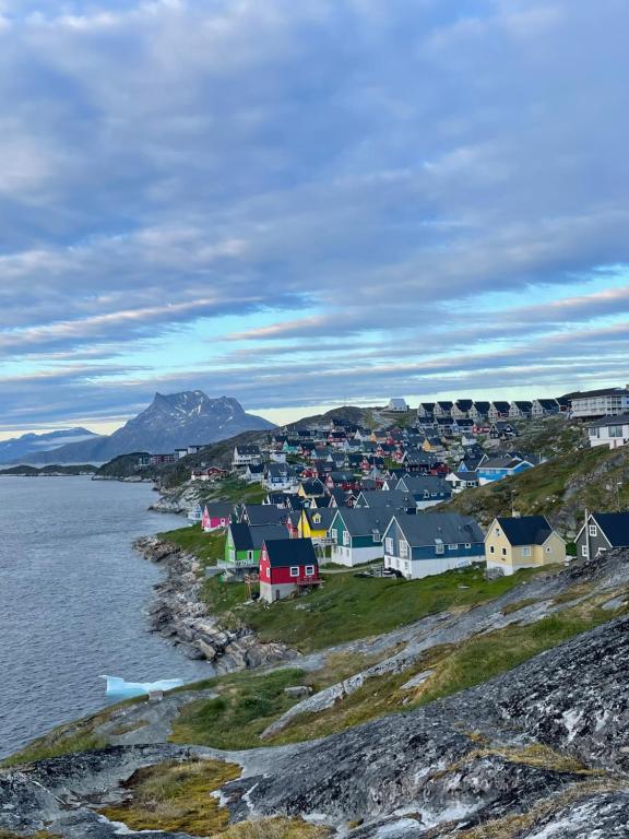 a village on the shore of a body of water at The White House in Nuuk