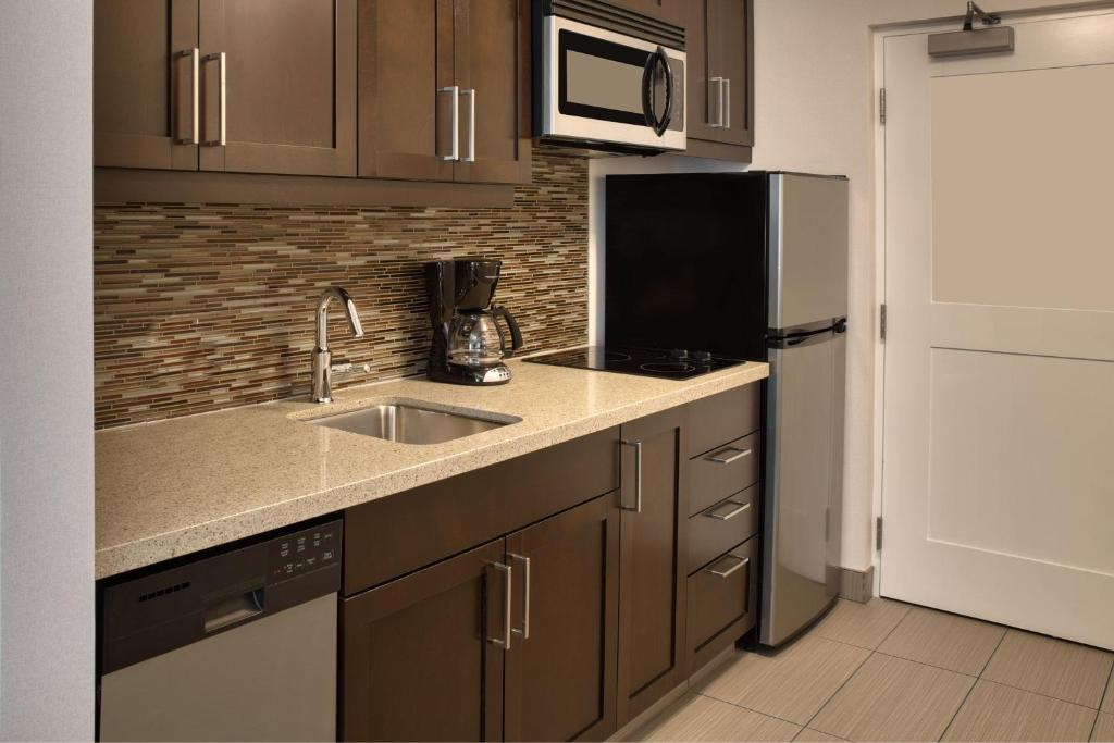 a kitchen with a sink and a refrigerator at TownePlace Suites by Marriott Belleville in Belleville