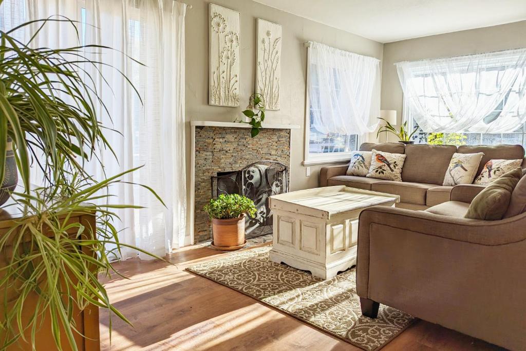 a living room with a couch and a fireplace at The Garden House of Downtown Manitou Springs in Manitou Springs
