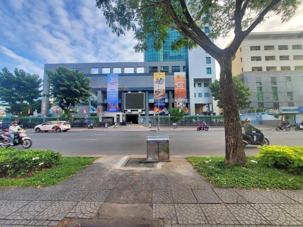 uma rua com uma árvore e uma placa em frente a um edifício em Deluxe Room have Balcony D1-Dakao em Ho Chi Minh