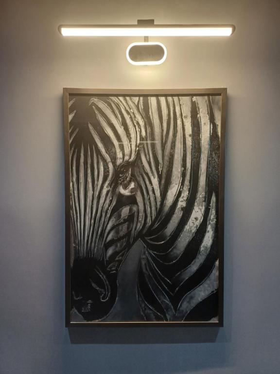 a painting of a zebra on a wall at Designed 2 rooms in Dushanbe