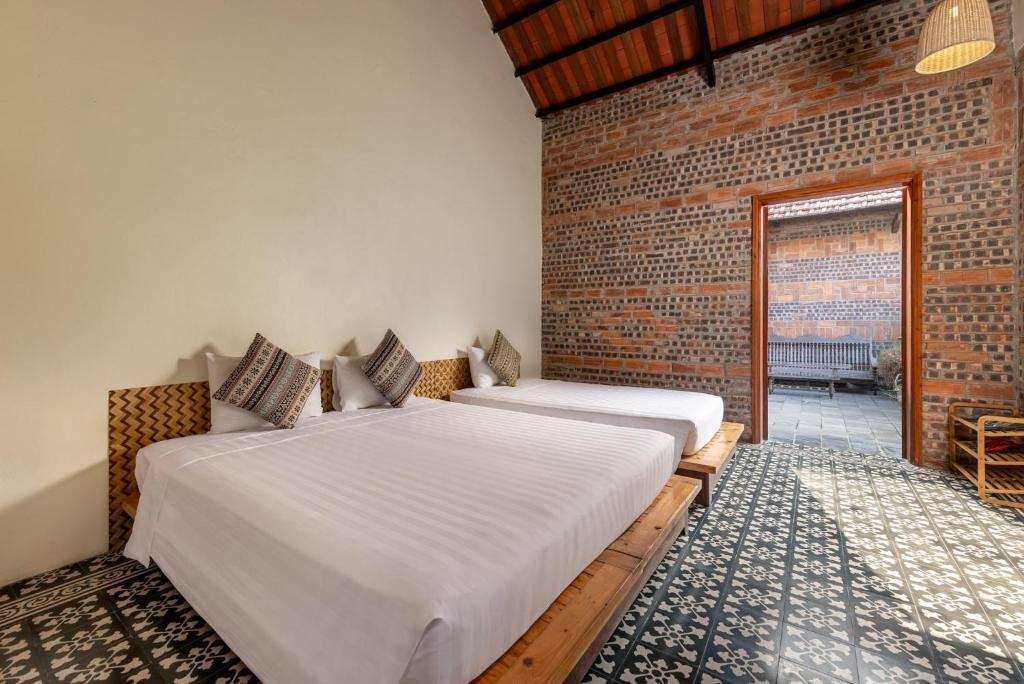 Postel nebo postele na pokoji v ubytování LittleTamCoc Boutique Villa Ninh Binh