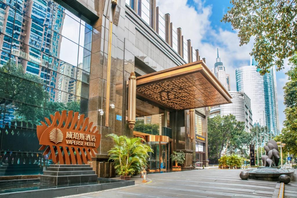 a building with a sign on the side of a street at Vaperse Hotel in Guangzhou