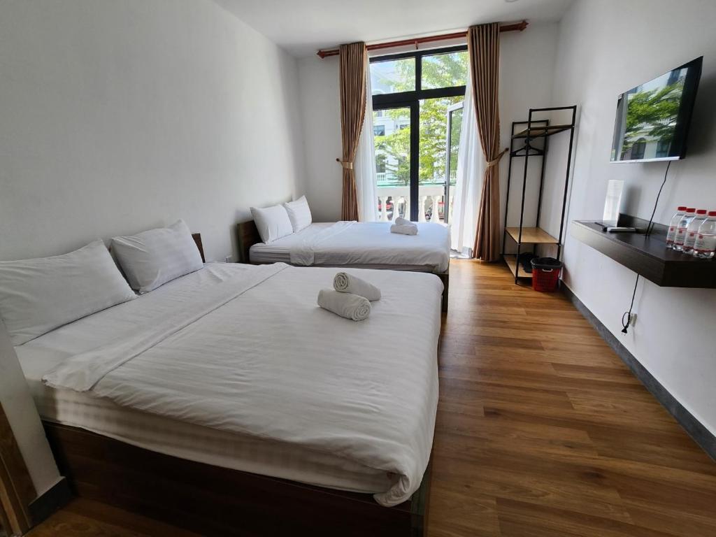 מיטה או מיטות בחדר ב-Lana Inn - Grand World Phú Quốc