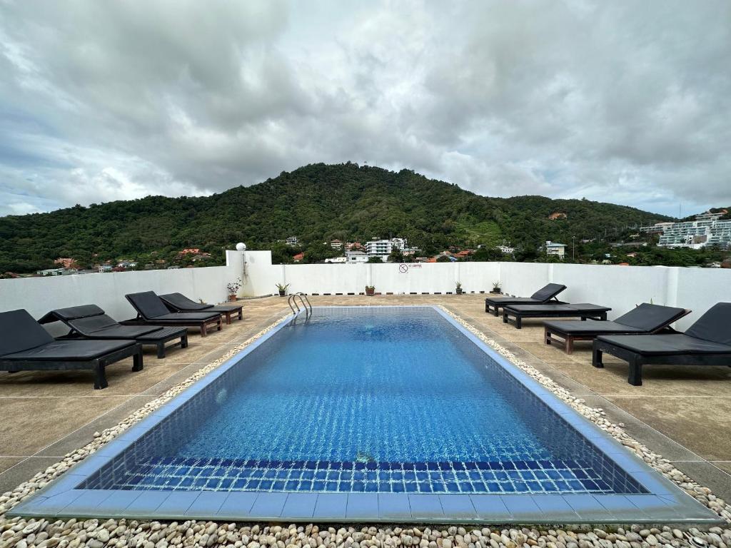 a swimming pool on the roof of a building at Kata Place Hotel in Kata Beach