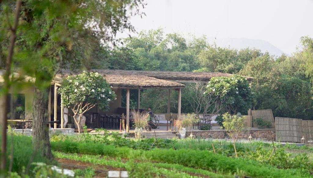 a house with a gazebo in a garden at Anopura Jaipur in Jaipur