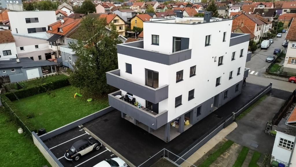 an aerial view of a white building in a city at Hugo apartments in Zagreb