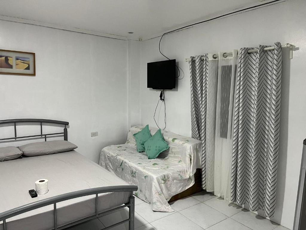 Postel nebo postele na pokoji v ubytování Nolina's Transient Rooms - Alaminos, Pangasinan