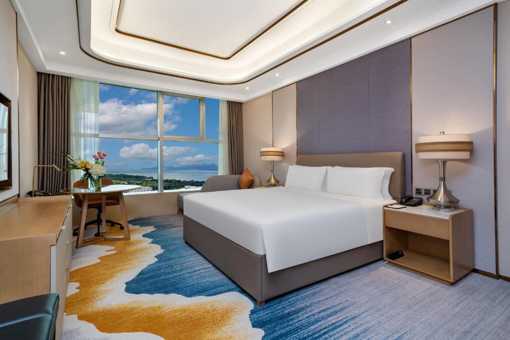 Postel nebo postele na pokoji v ubytování Oriental Ginza Hotel Shenzhen
