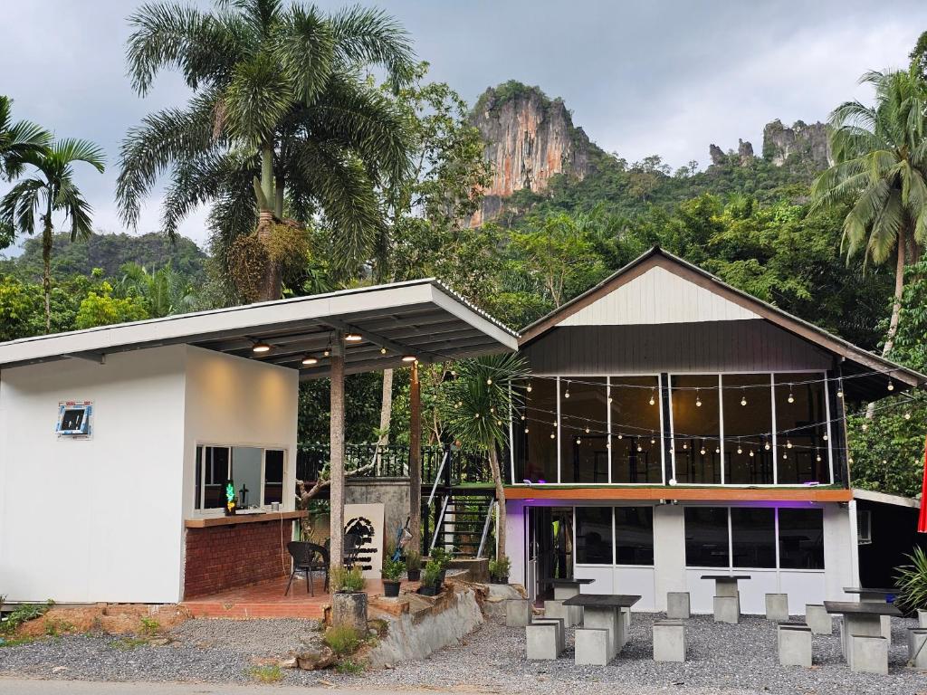 a building with a mountain in the background at Nahm Khao Sok in Khao Sok National Park