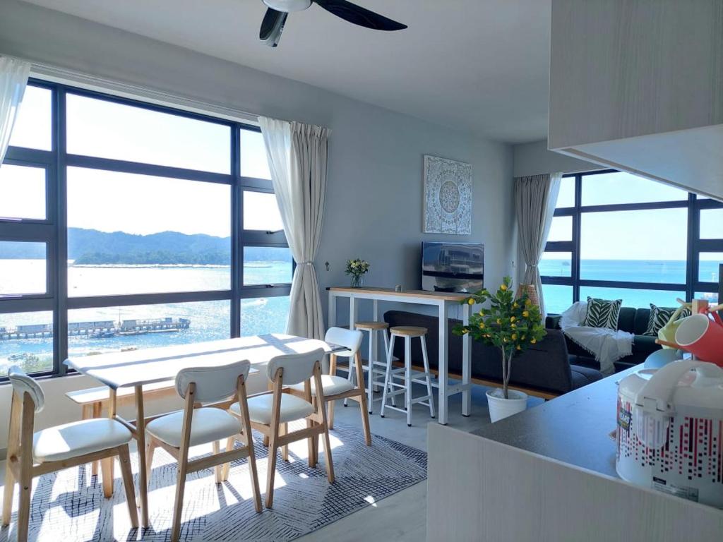 a kitchen and living room with a view of the ocean at J' Stay Jesselton Quay City Centre 邻近码头 in Kota Kinabalu