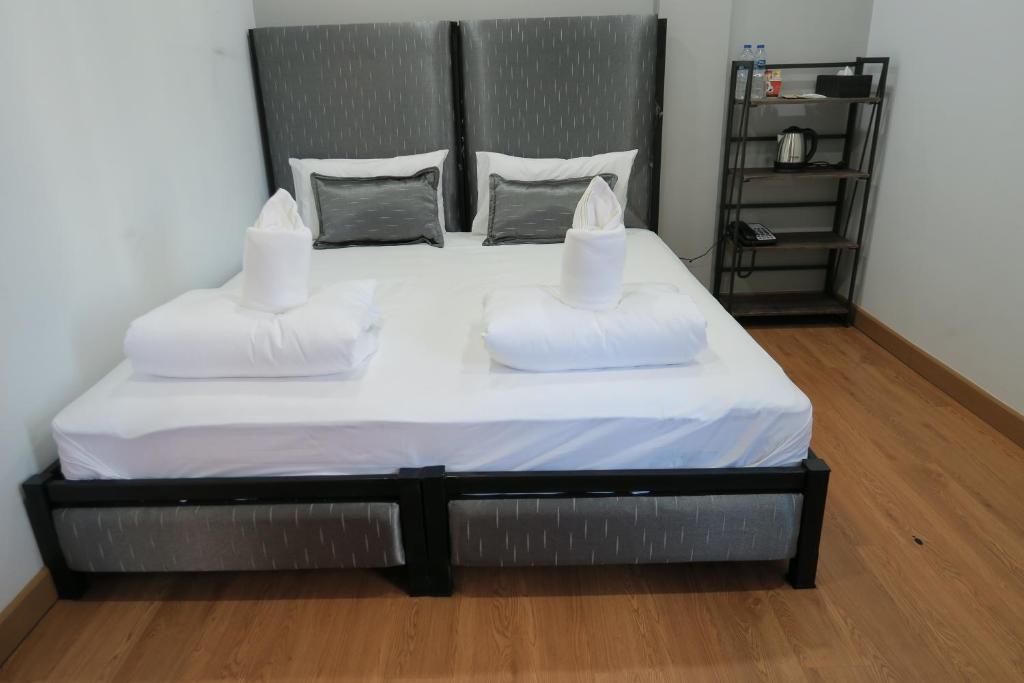 Postel nebo postele na pokoji v ubytování The Mira Hotel Chiang Rai