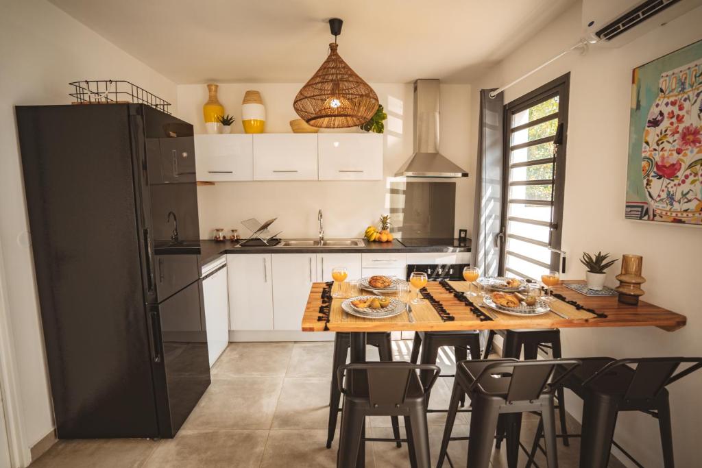 a kitchen with a table with food on it at KozyKaz, notre villa cocooning avec piscine in Saint-Pierre