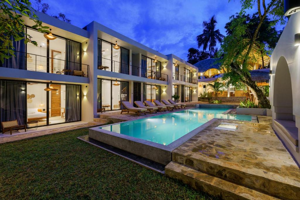 an exterior view of a villa with a swimming pool at Terra Resort in Ahangama