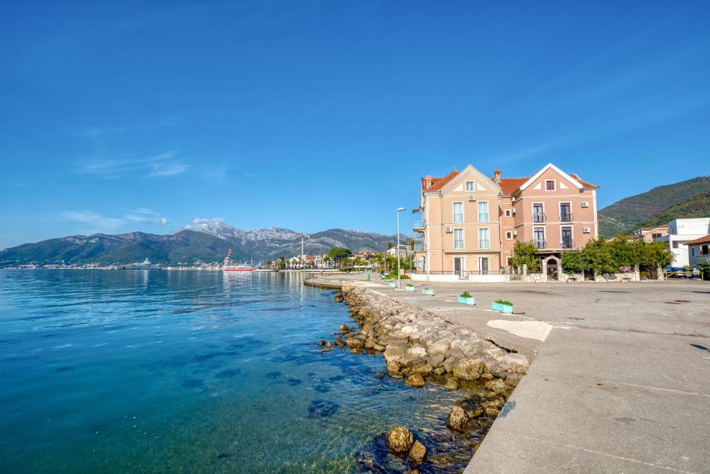 a large building next to a body of water at Tivat Star in Tivat