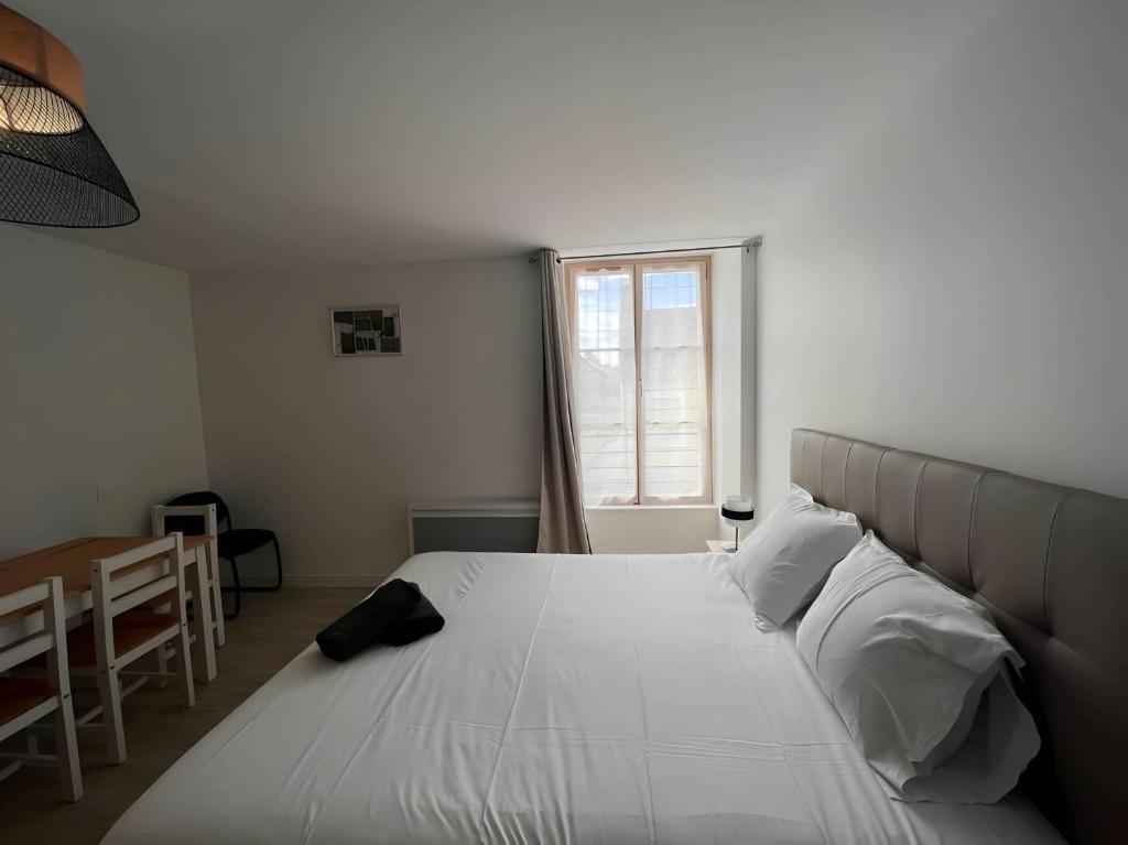 a bedroom with a large white bed with a window at Les Orchidées - Campagne - 2pers - Rêve au Mans in Saint-Mars-sous-Ballon
