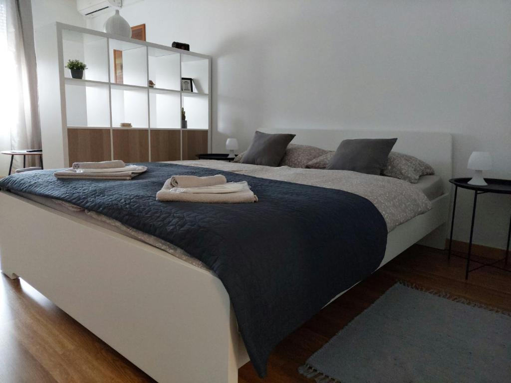 a bedroom with a large bed with two towels on it at M&M Apartment in Velika Gorica