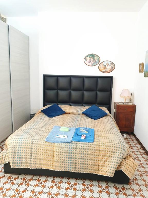 a bedroom with a large bed with blue pillows at LA CASA DEI PARGOLI JUNIOR in Matera