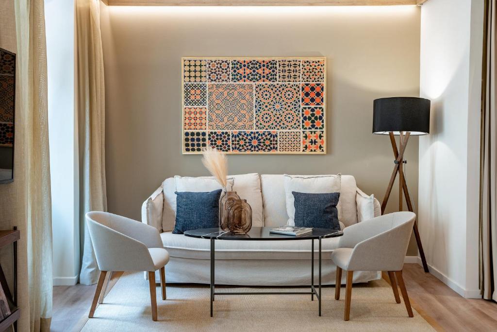 a living room with a table and a couch at Meliá Granada in Granada