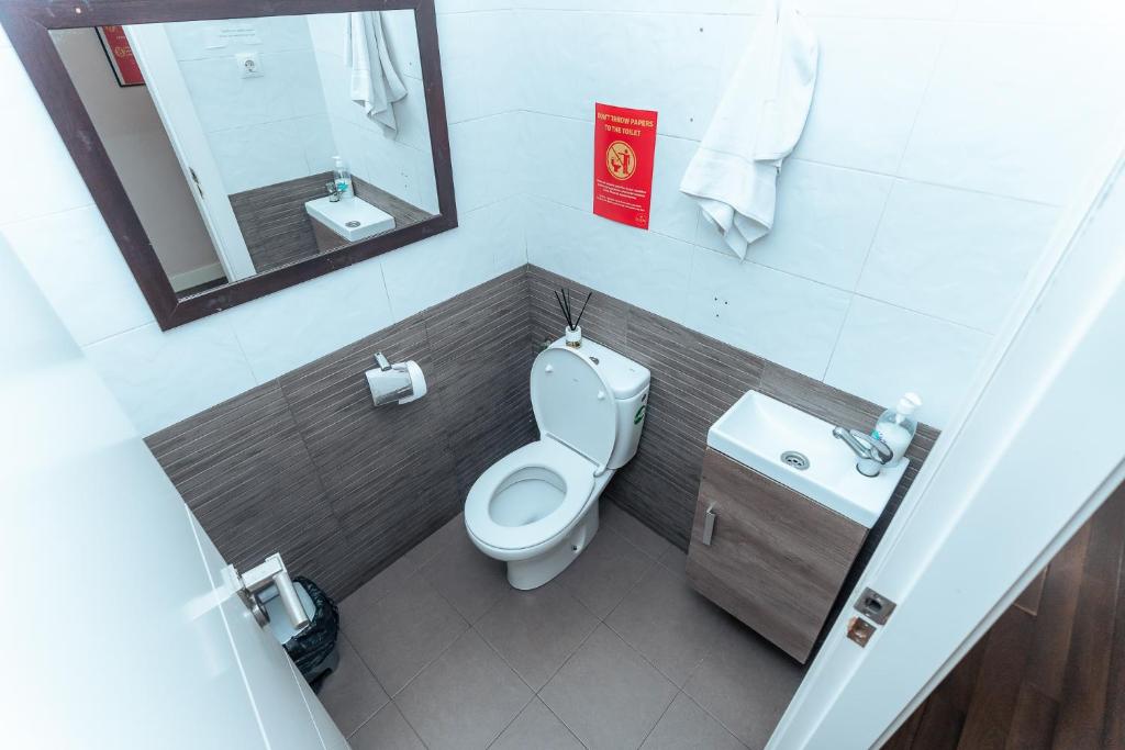 a small bathroom with a toilet and a sink at Barcelona & You Hostel Sagrada Familia in Barcelona