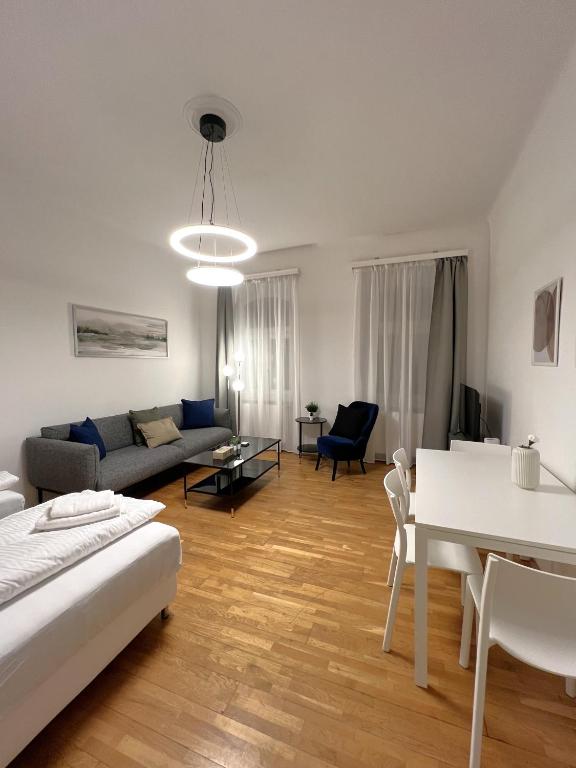 a living room with a couch and a table at Charming Apartment close to Vienna Central Station in Vienna