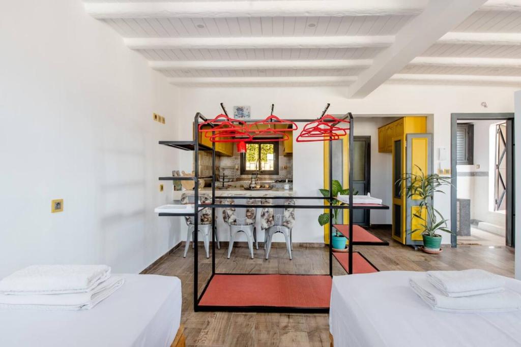 a room with two beds and a table with chairs at Studio Rooftop in Tangier