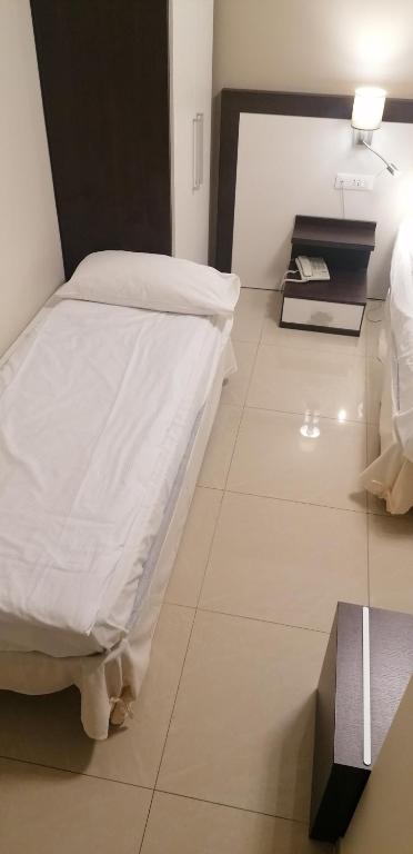 Кровать или кровати в номере Hotel Boccascena