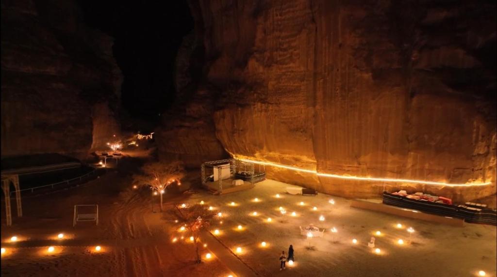 an aerial view of a cave at night with lights at Sahary Al Ula Resort in AlUla