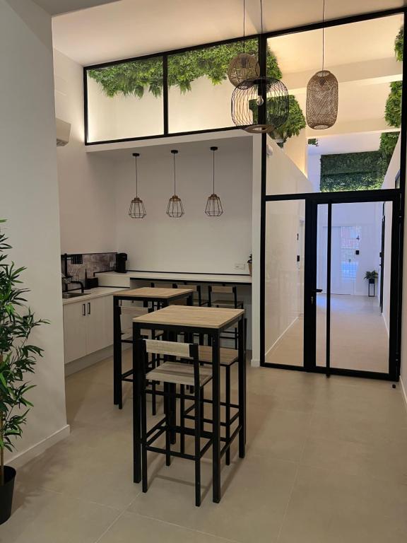 a kitchen with tables and chairs in a room at Niña Mala in Valencia
