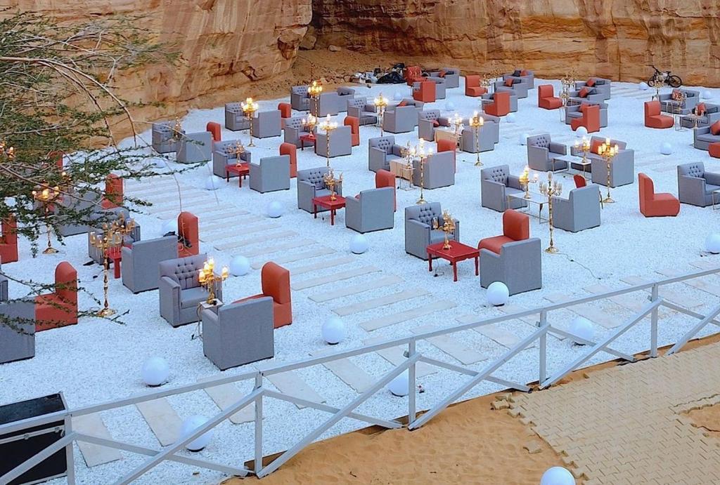 a group of tables and chairs in the desert at Sahary Al Ula Resort in AlUla