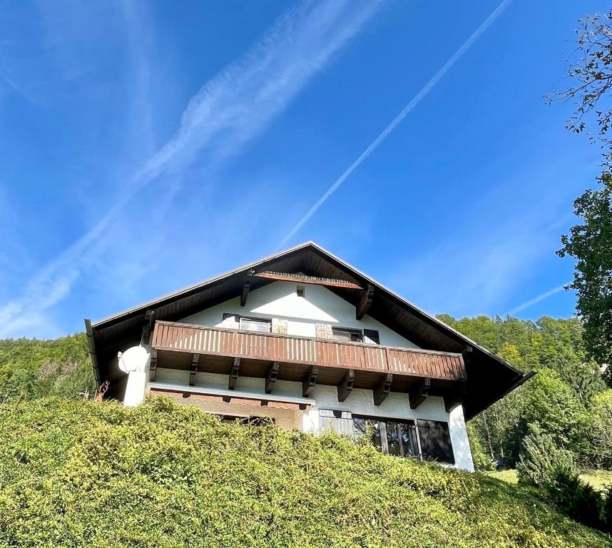 a house on top of a grass covered hill at Ferienhaus sHäuserl in Landl