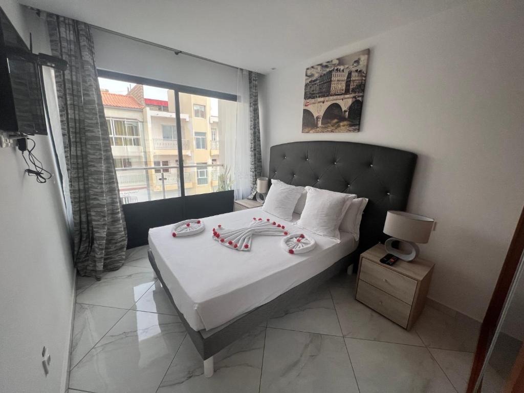 a bedroom with a bed with candy canes on it at Residencial Santo Amaro in Tarrafal