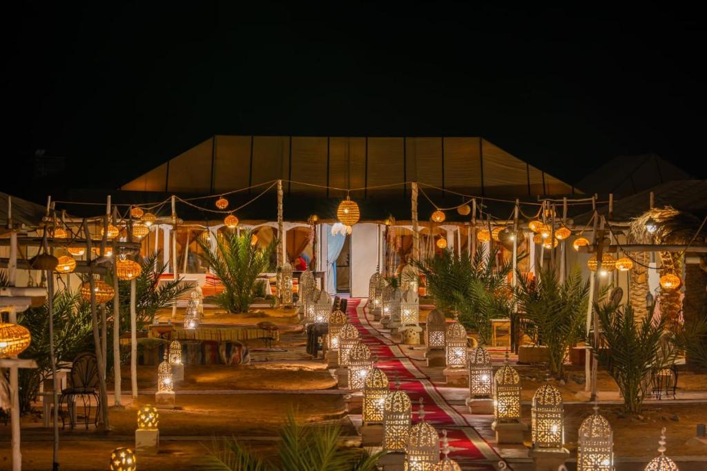 a group of lights in front of a tent at Authentic Luxury Camp in Merzouga
