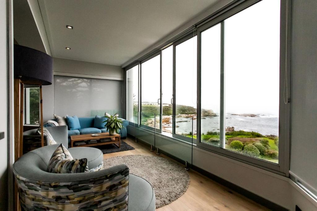 a living room with a view of the ocean at Bayview 303 in Hermanus