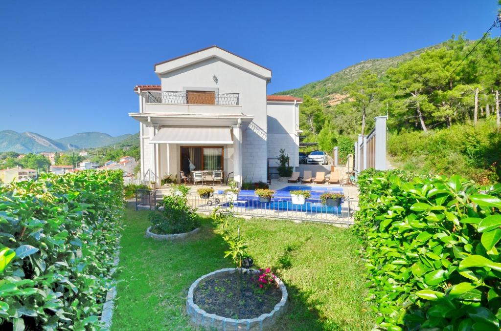 a villa with a view of a garden at Sunny Villa in Kavac in Tivat