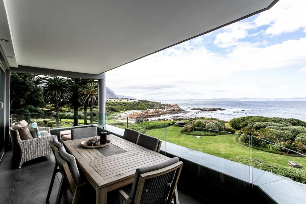 a dining room with a view of the ocean at Bayview 203 in Hermanus