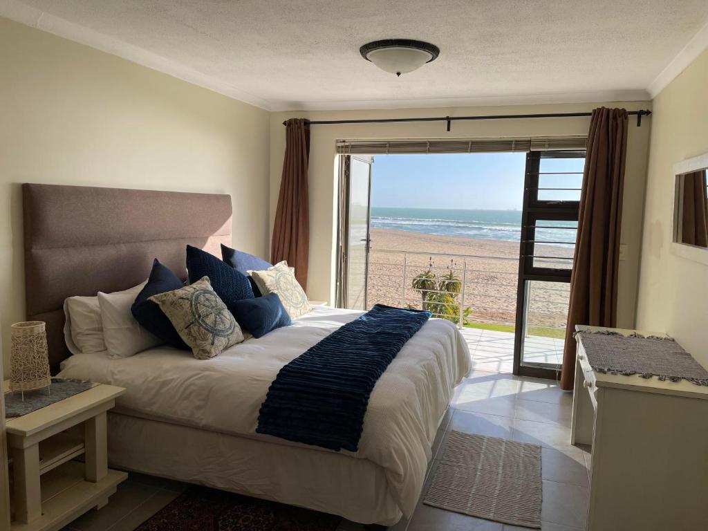 a bedroom with a bed with a view of the beach at Ocean Dream Self-Catering in Swakopmund