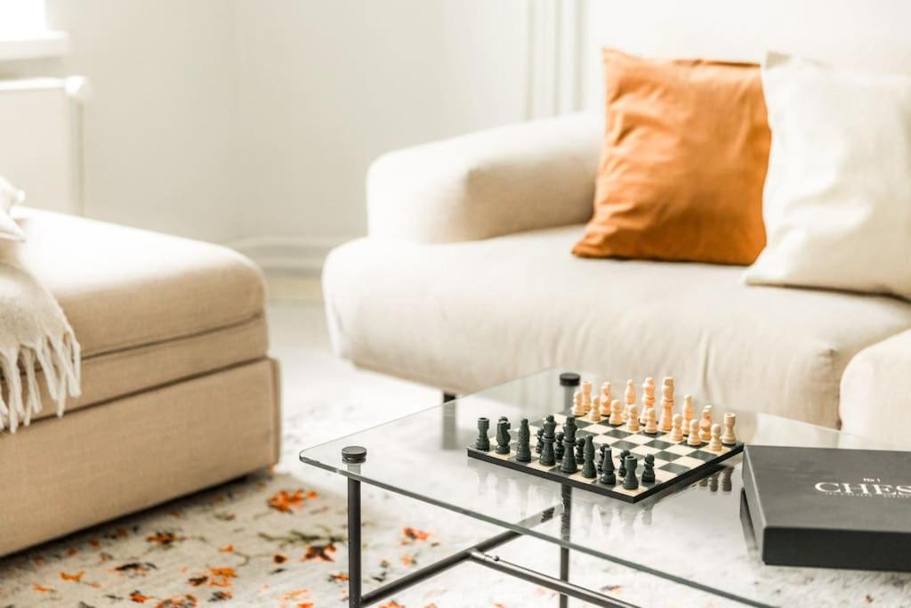 a living room with a chessboard on a coffee table at Downtown Light-Filled Retreat in Helsinki