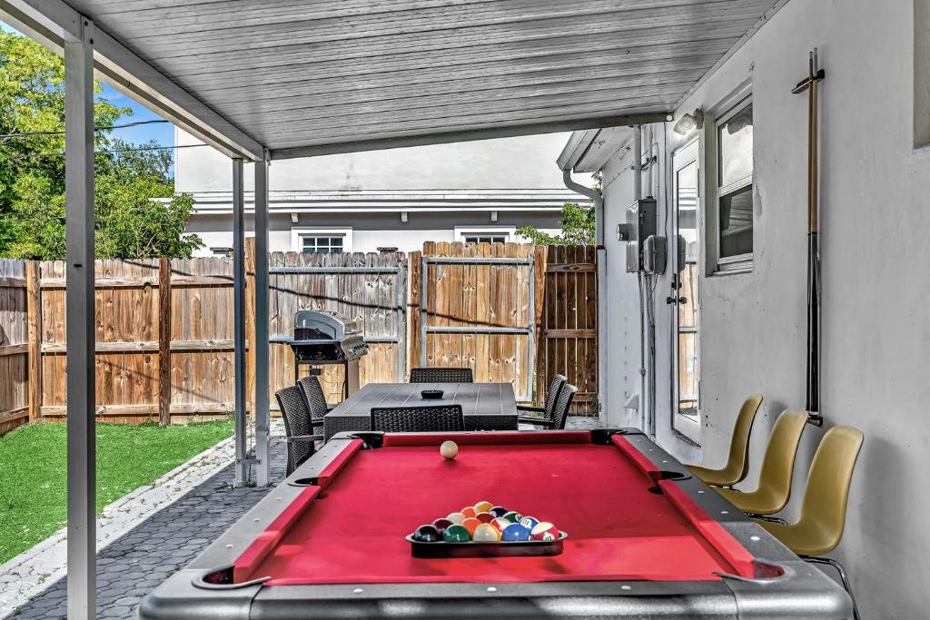a ping pong table on a patio with a pool table at 3 Bedroom Villa In F Lauderdale Casino & Beach in Fort Lauderdale